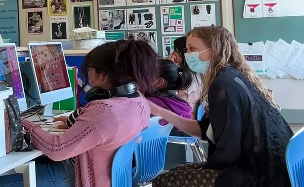 Working with students on a digital media project.